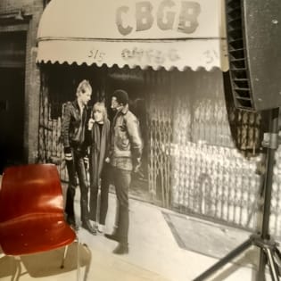 Ein Stuhl für Besucher steht vor einem XXL- Wandbild aus den 70er Jahren